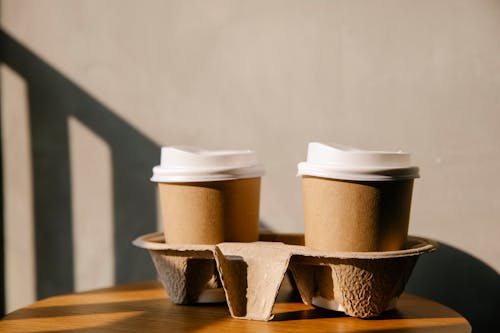 Cardboard cups on holder tray on table