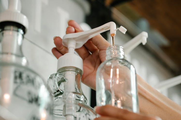 Crop Person Pushing Soap From Dispenser