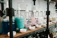 Raw of big dispensers with multicolored shampoo