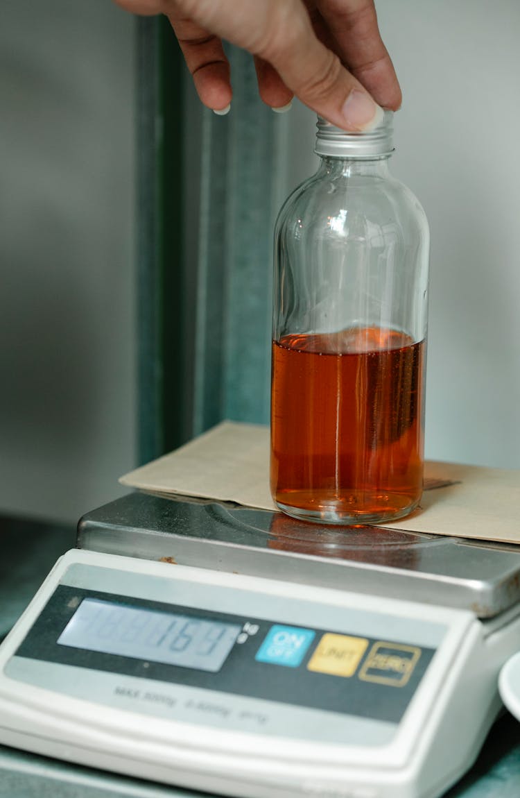 Weighing A Bottle Of Liquid