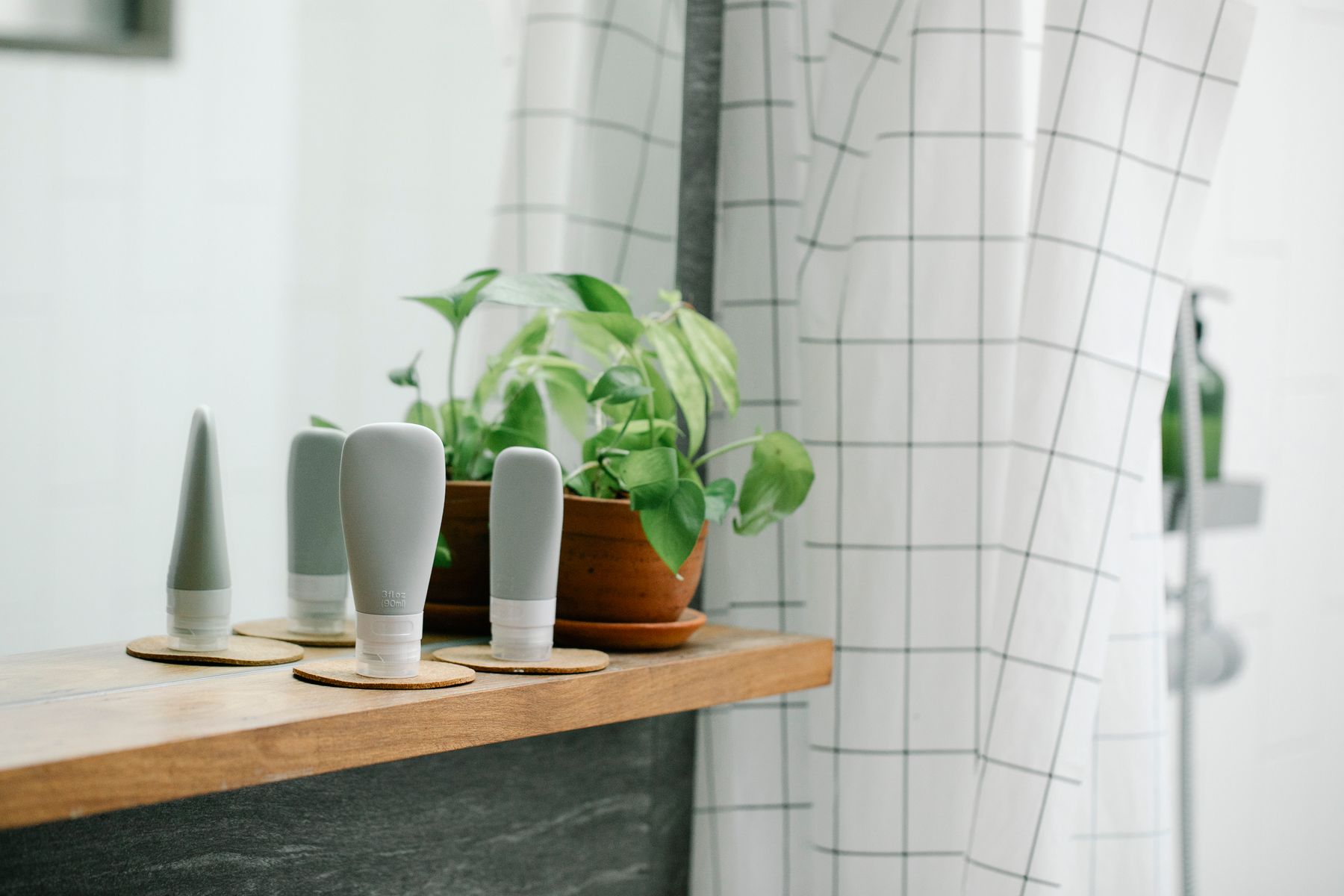 Skincare and body care products arranged on a clean bathroom shelf