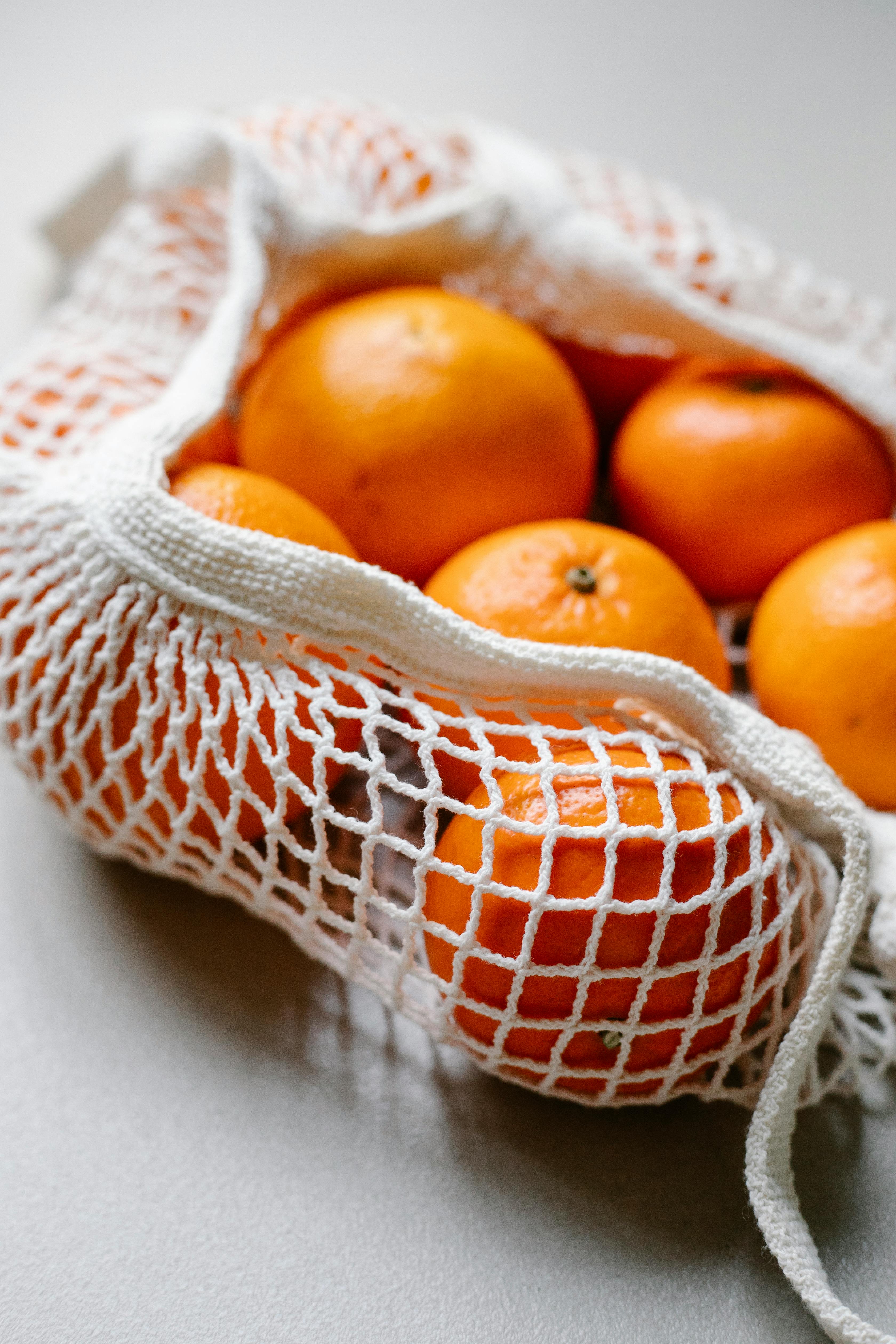 Fresh tangerines in a netted bag, Stock image