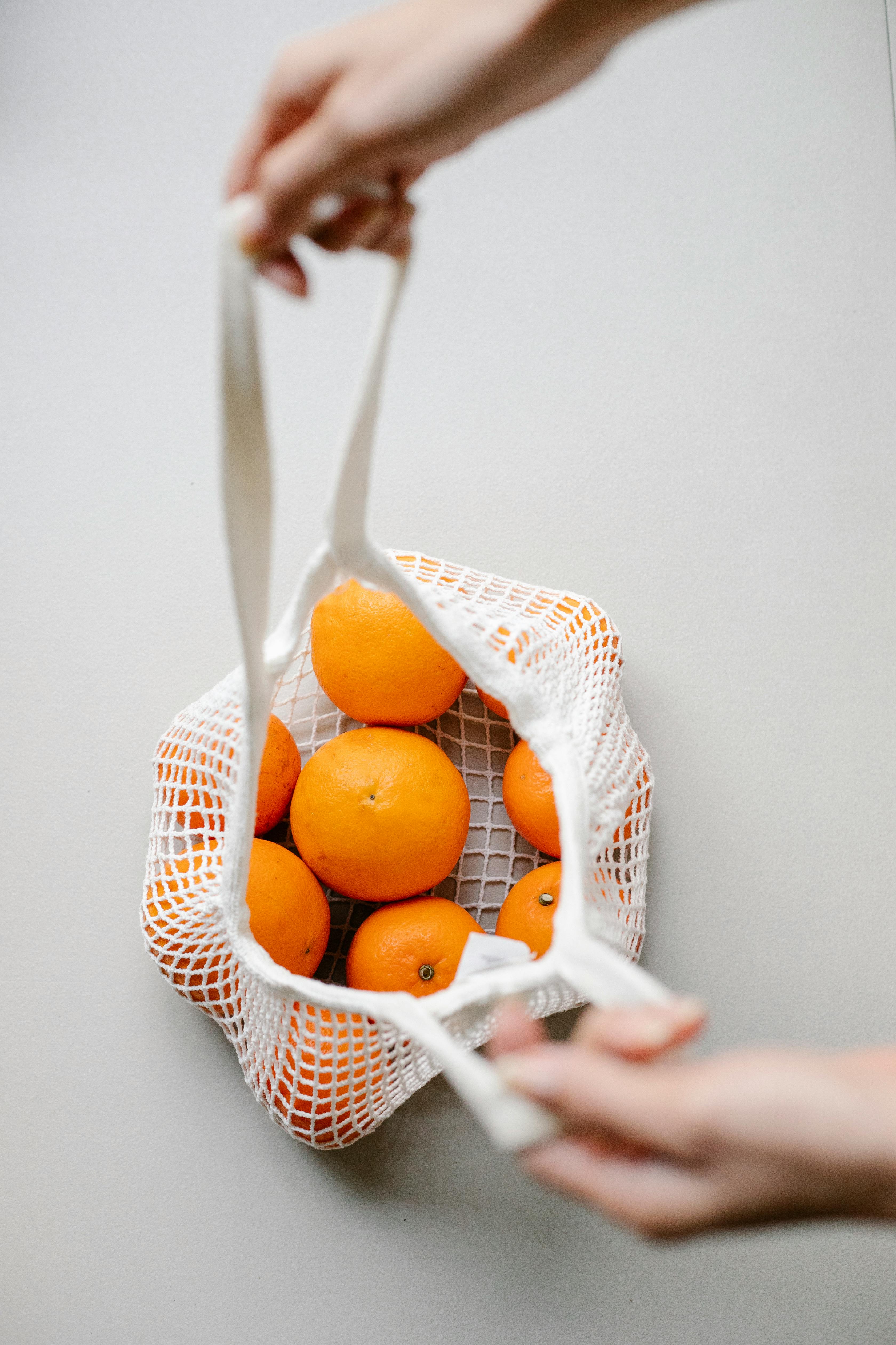 Fresh orange tangerines in wicker bag · Free Stock Photo