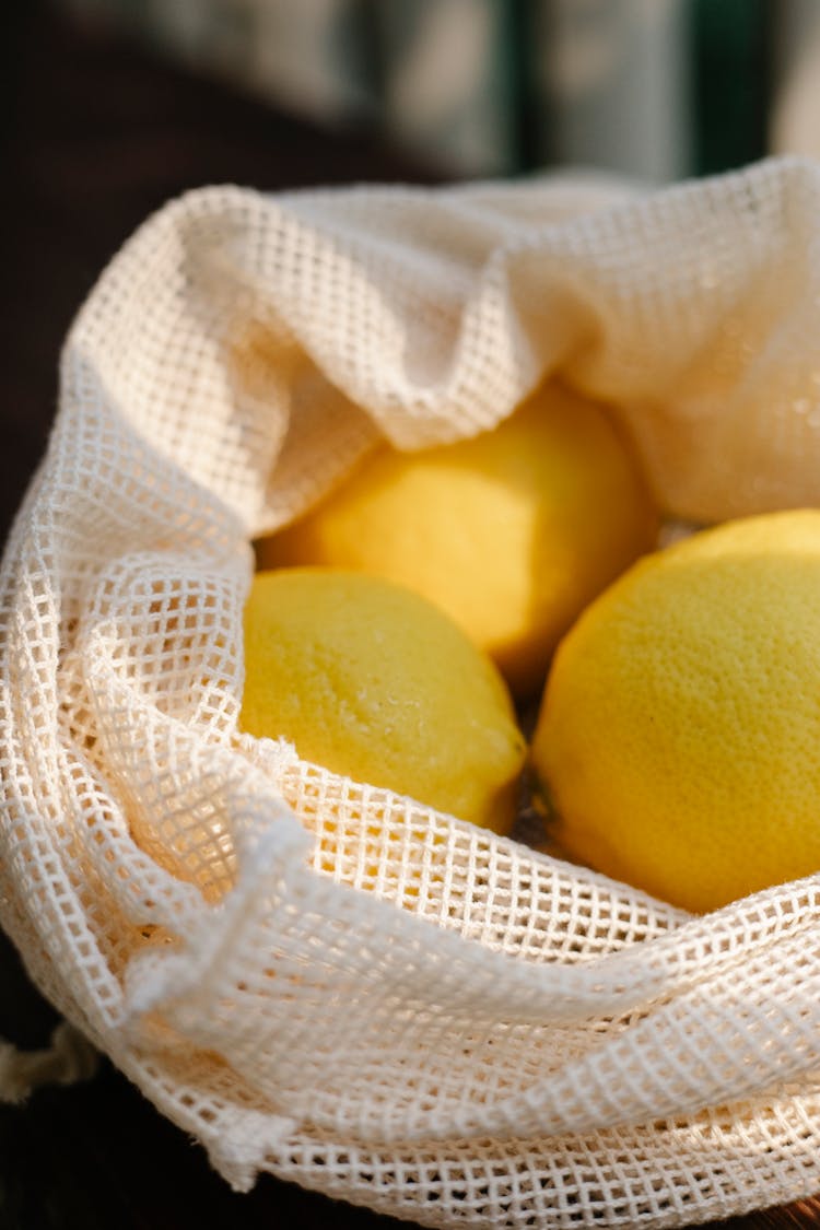 Pile Of Lemons In Mesh Bag