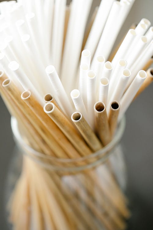 Set of reusable straws in glass bowl