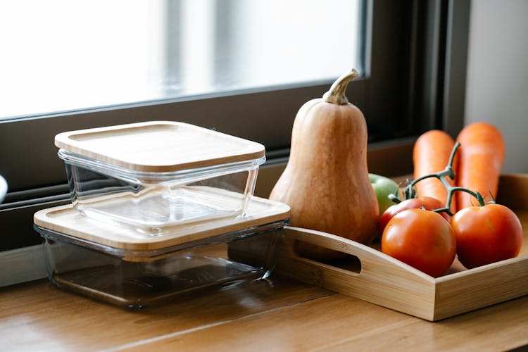 Ripe Vegetables And Glass Jars Placed On Kitchen Counter