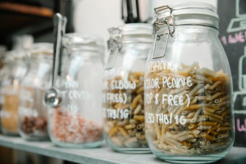 Set of glass jars with pasta and various products