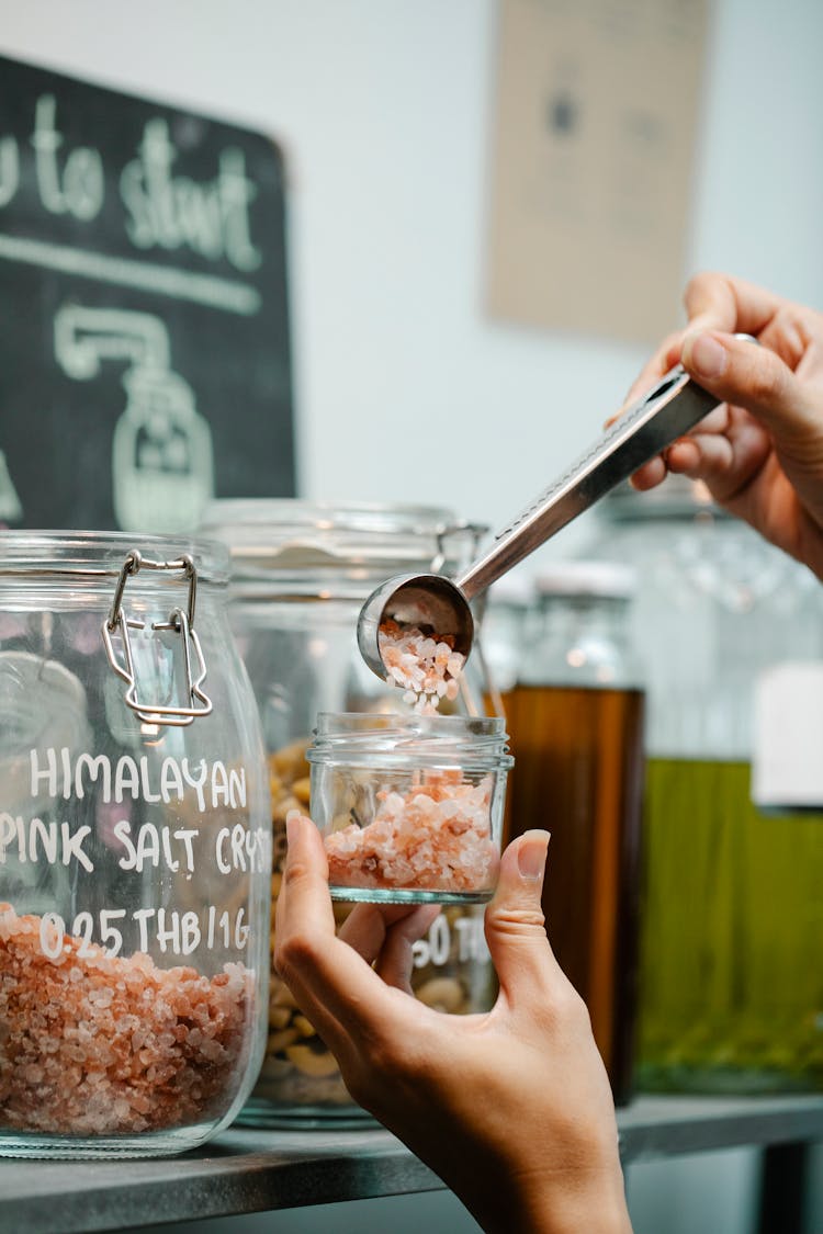 Crop Tester Putting Spice Specimen Into Glass Jar