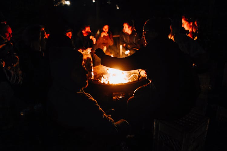 People Gathered Around The Fire Pit