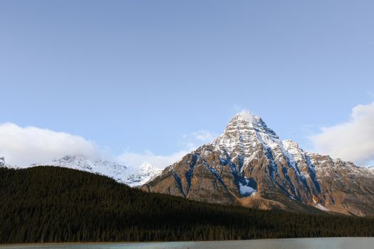 Beautiful scenic view of a snow-capped mountain under a clear blue sky.