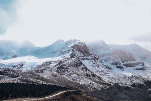 Free Stunning view of snow-capped mountains under a clear sky, perfect for nature enthusiasts. Stock Photo