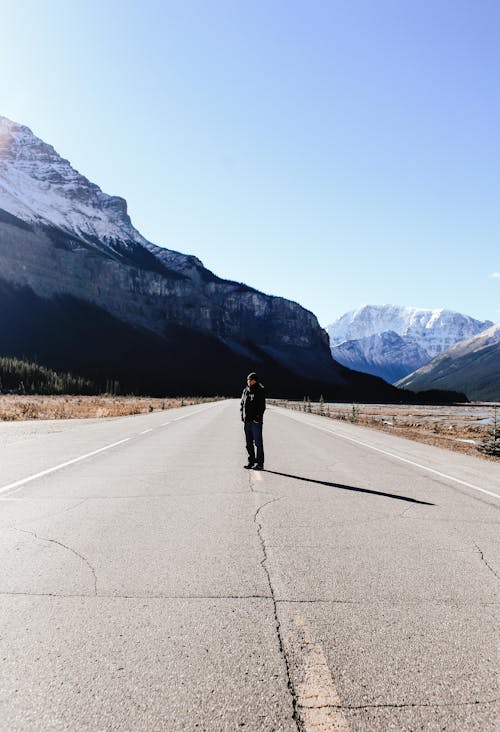 Person Standing in the Middle of the Road 