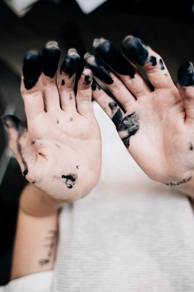 Close-Up Shot Of Hands With Black Paint