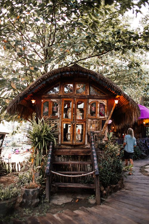 Free Charming rustic cottage nestled in greenery, capturing a serene village ambiance. Stock Photo