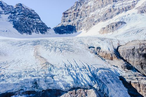 Free Vibrant winter scene of snow-covered mountains and glaciers under a clear sky. Stock Photo