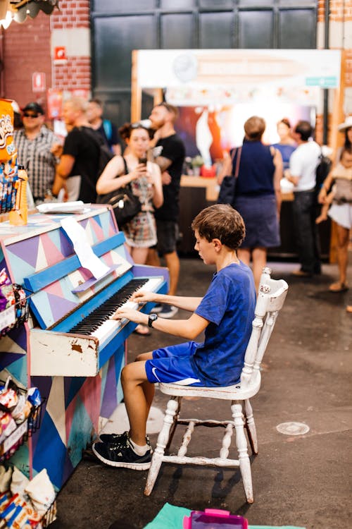 Boy in Blue T-shirt Playing Piano