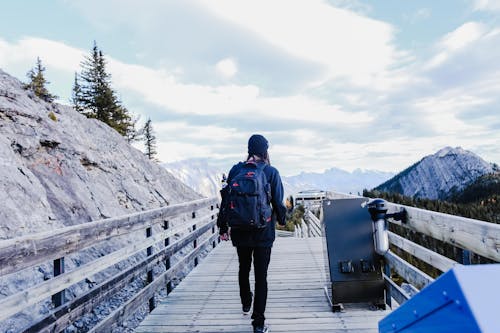 Person Walking on Wooden Deck