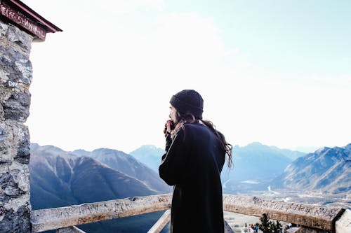Free Man with Long Hair Overlooking  the Mountains Stock Photo