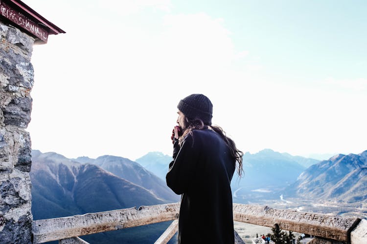 Man With Long Hair Overlooking  The Mountains