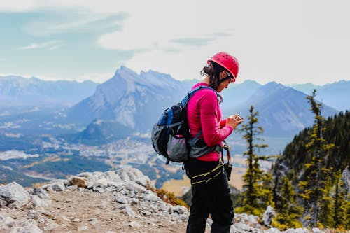 Free A Woman near Cliff using Smartphone Stock Photo