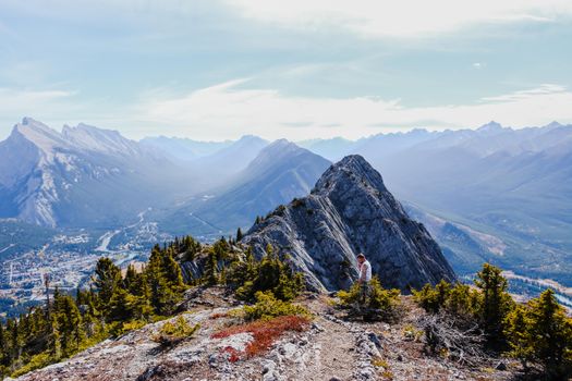 Scenic view of mountains with a lone hiker in Banff National Park, Alberta.