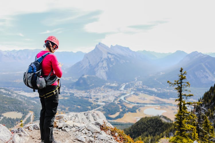 Woman Wearing Sweater Standing On Mountain Top