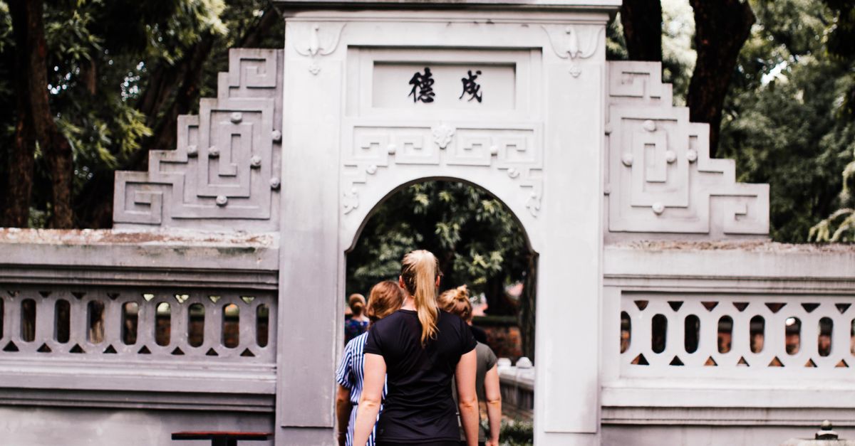 Gate Fun Walk People Walking Through a Gate in a Park · Free Stock Photo