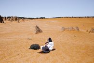 2 Person Sitting on Brown Sand