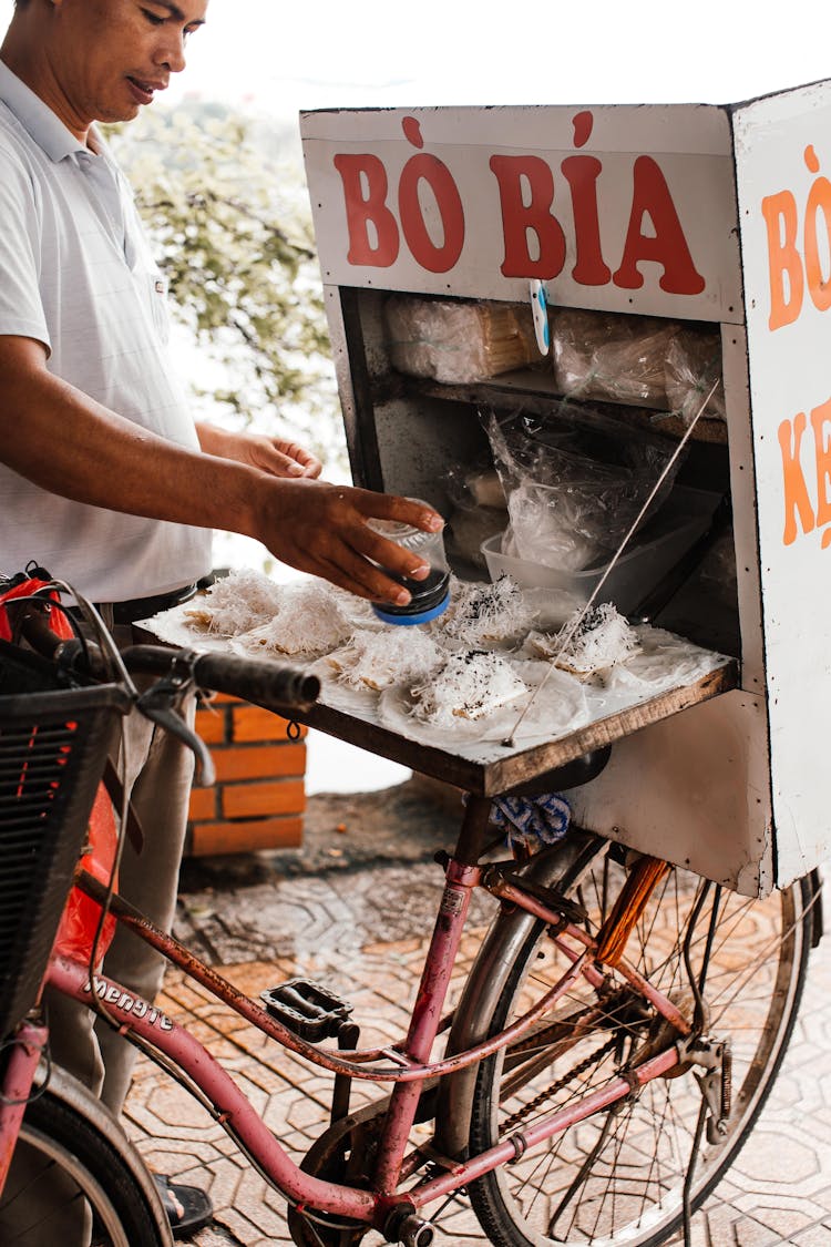 Man Selling Traditional Food On Bike On Street