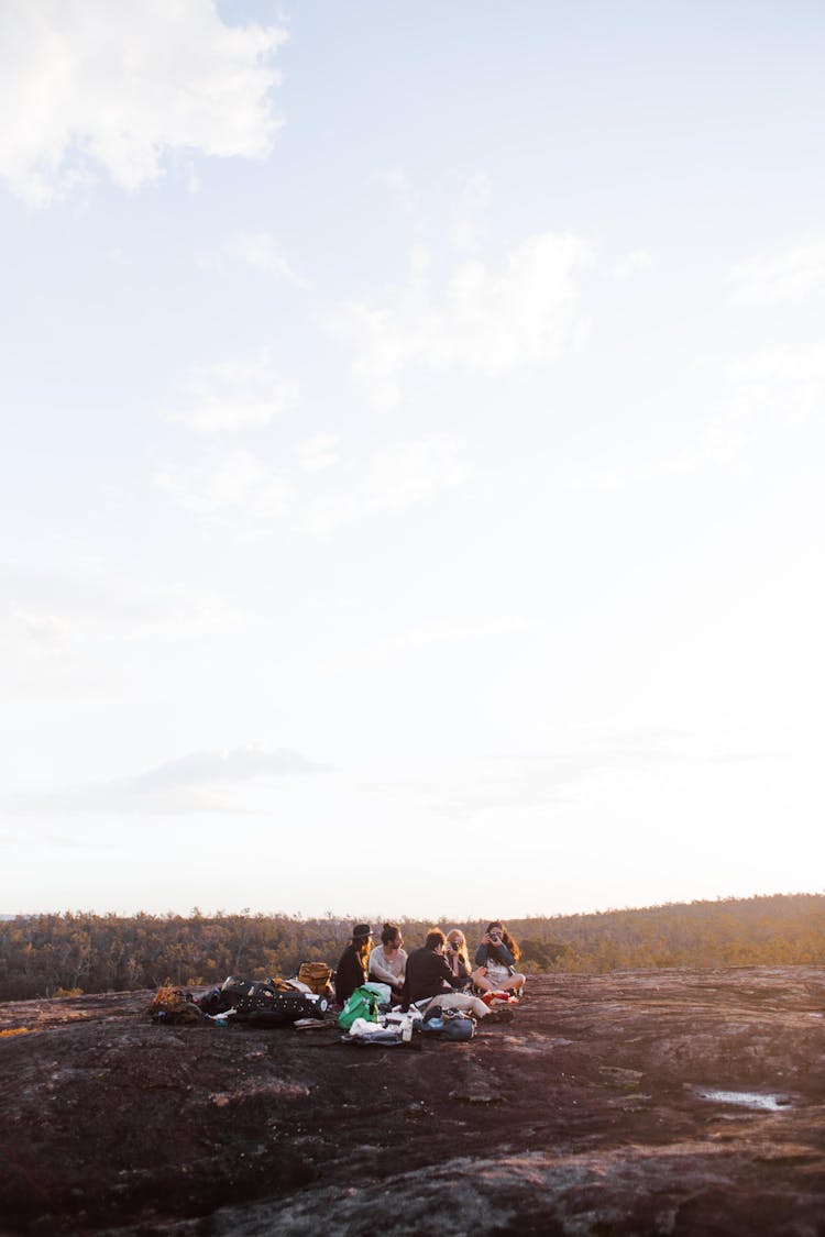 A Group Of Friends Sitting On The Ground