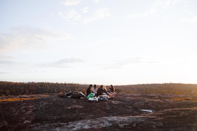 A Group Of Friends Sitting On The Ground