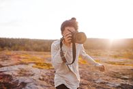 Man in White Long Sleeve Shirt Holding Camera