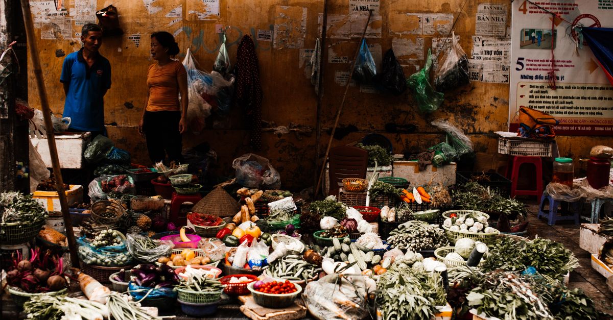 local market scene with fresh produce and vendors in a small European town