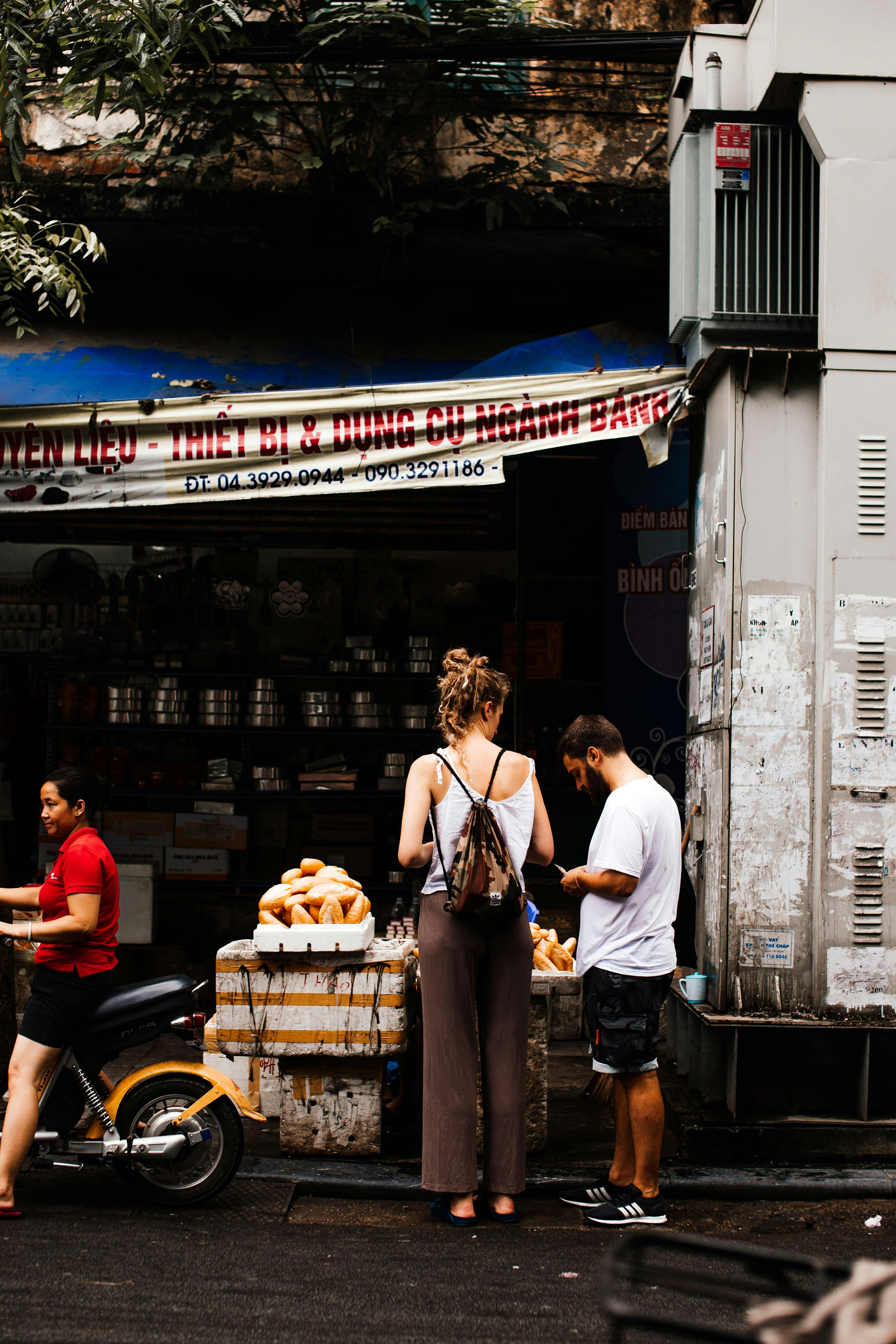 tourists buying fruits from the street vendor