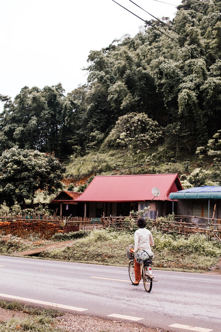 A Woman Riding Bicycle On The Road