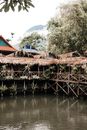 Brown Wooden Nipa Huts on Body of Water