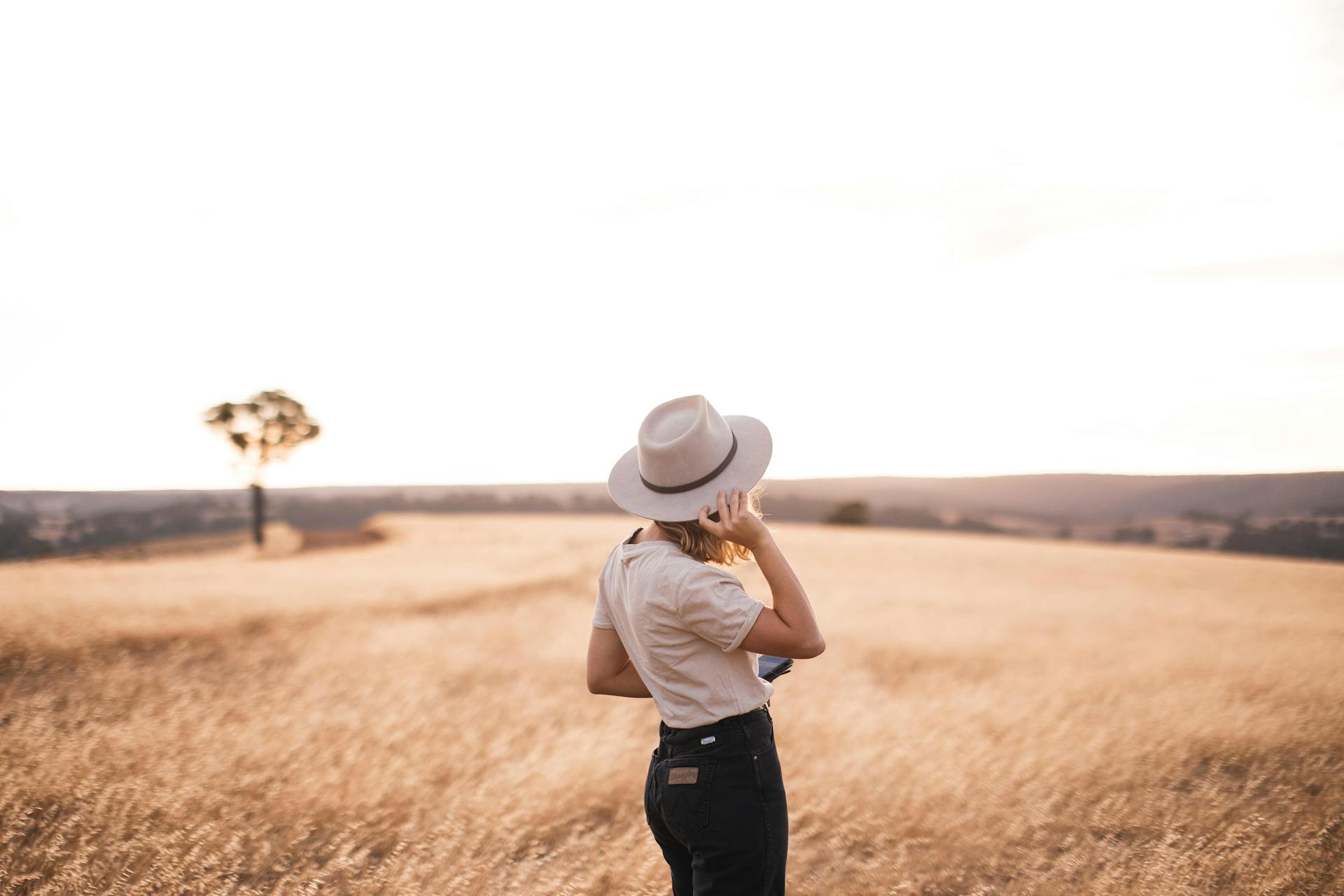 A Woman in White Shirt Wearing White Hat