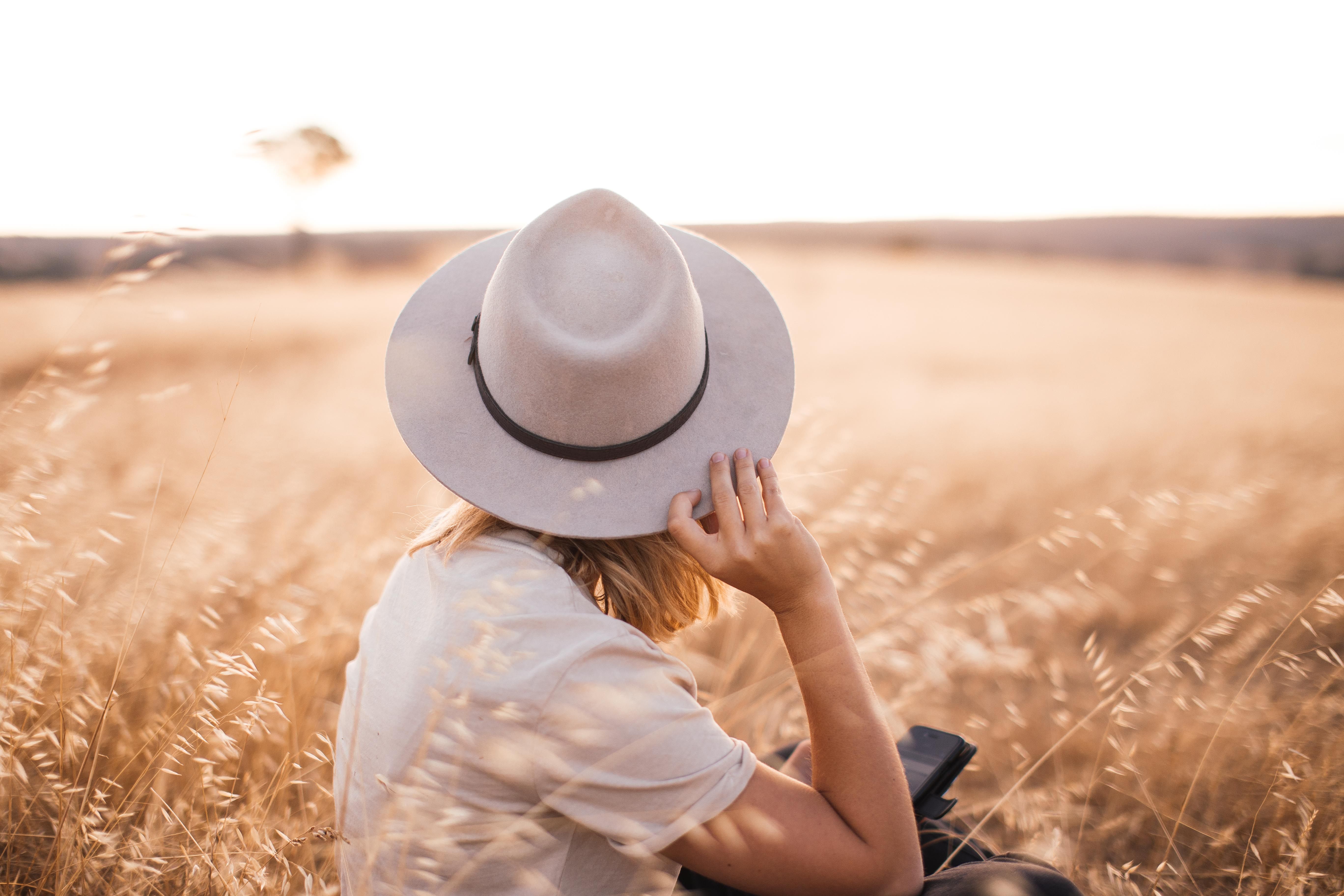 A Woman Sitting on Brown Grass Field · Free Stock Photo