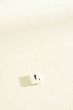 A single Scrabble tile showing the letter 'I' on a white background with shadows, offering ample copy space.