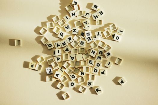 A close-up view of scattered letter tiles on a light surface, ideal for educational themes.