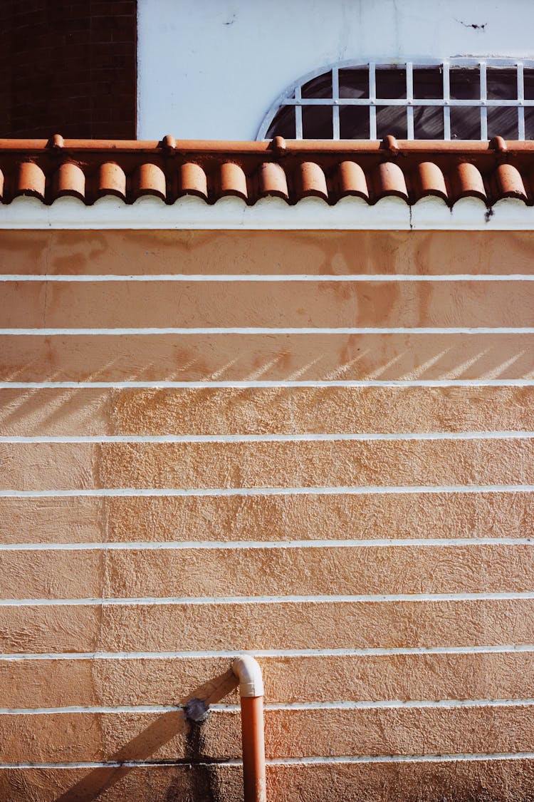 Close Up Of A Beige Wall With Stripes And Ceramic Tiles