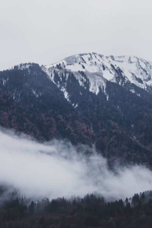 Free Breathtaking view of snow-covered mountains in La Grave, France, enveloped in mist. Stock Photo