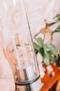 Clear Glass Bottle on White Textile