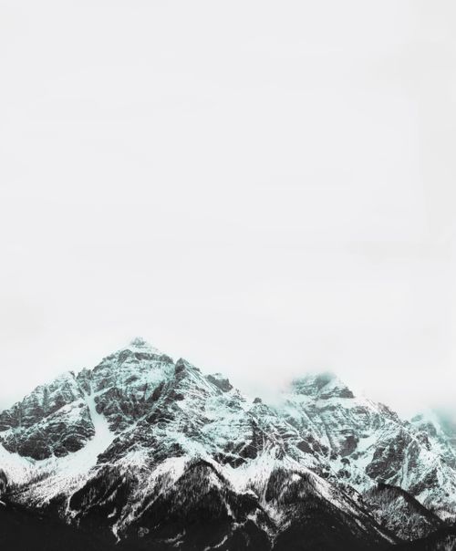 Free Scenery of rough snowy mountain ridges covered with snow under gloomy sky in winter day Stock Photo