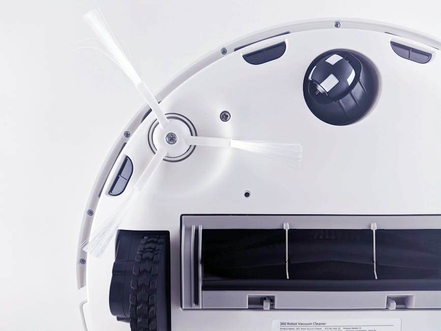 Best Robot Vacuums for Every Budget and Need (2025 Complete Guide) Close-up of a modern robotic vacuum cleaner underside showing brushes and components.