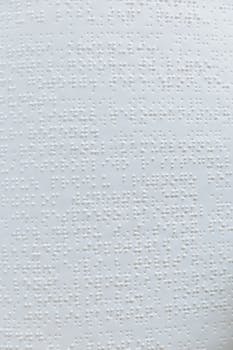 Detailed close-up of a Braille text page, showcasing tactile embossing.