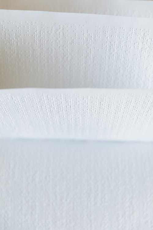 Close-Up Shot of White Braille Paper