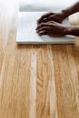 Person Using Macbook on Brown Wooden Table
