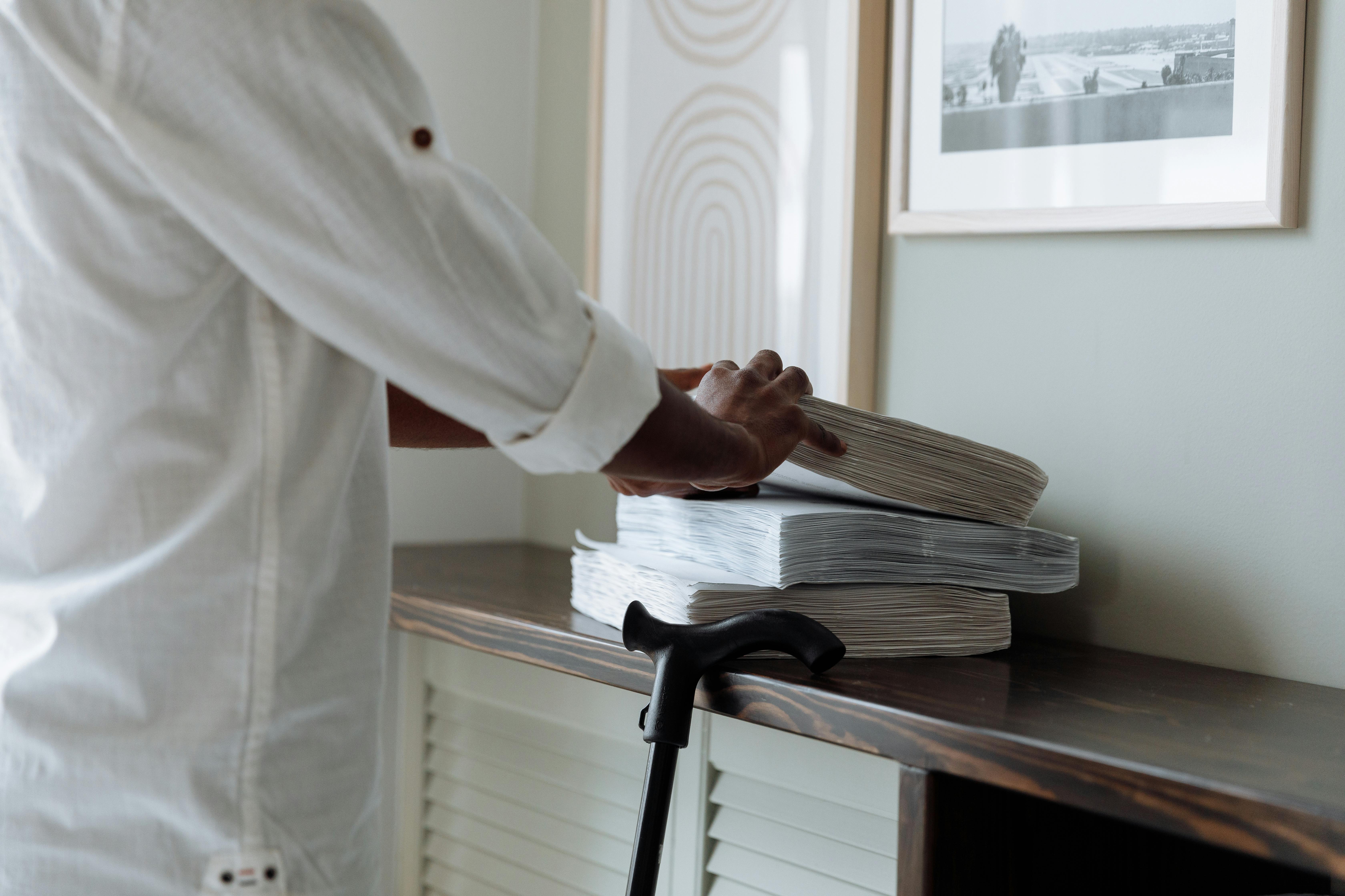 man in white robe holding white paper