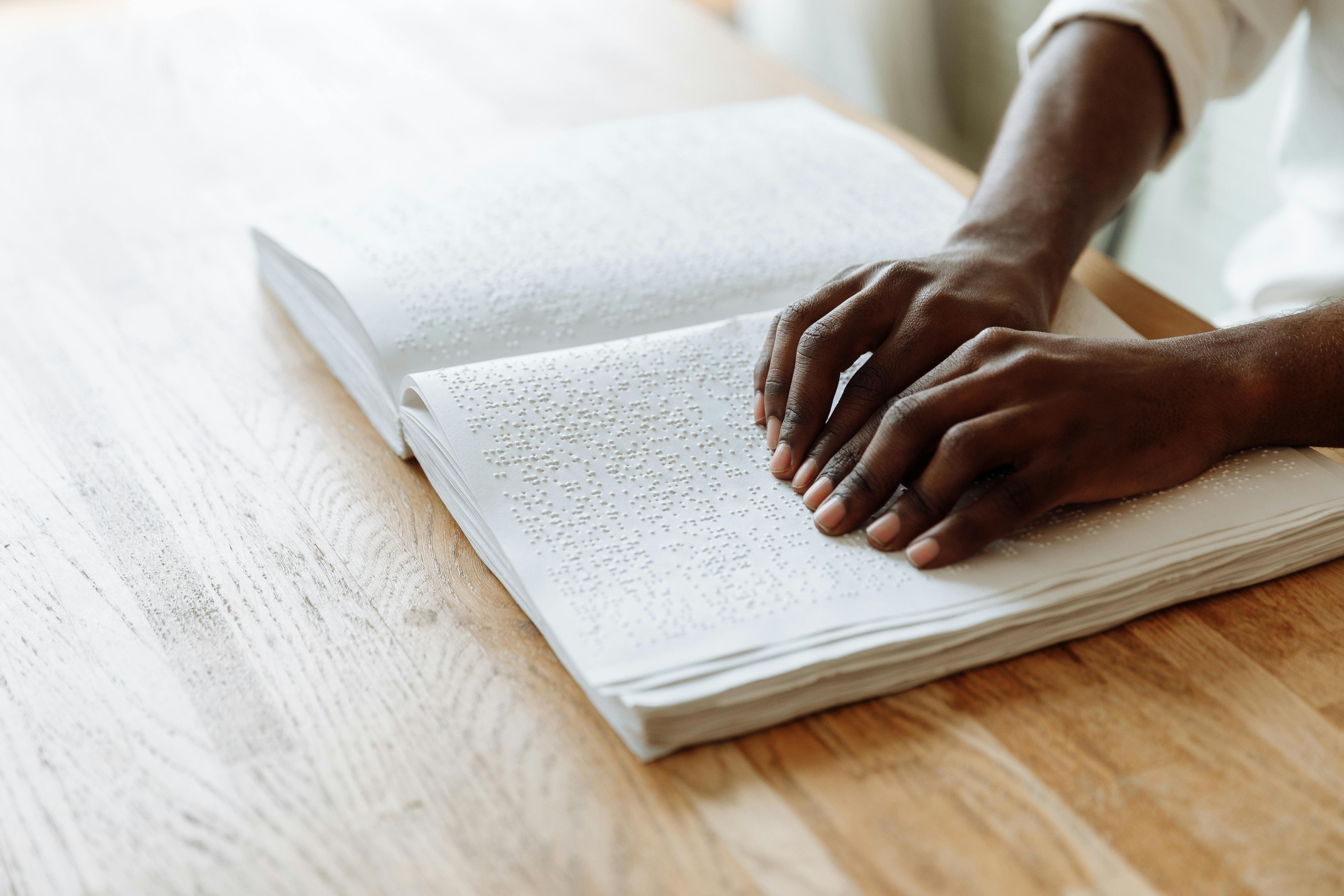 hands touching braille book